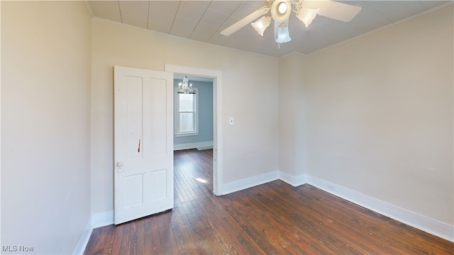unfurnished room featuring dark wood-style floors, baseboards, crown molding, and ceiling fan with notable chandelier