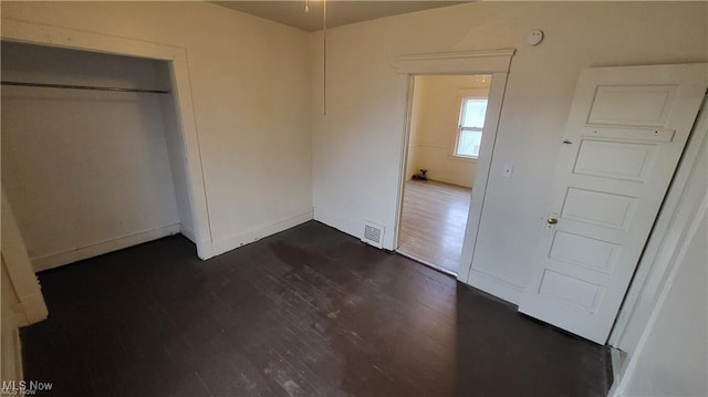 12614 Forest Ave, Cleveland, OH 44120 - unfurnished bedroom with visible vents, baseboards, a closet, and dark wood-style floors