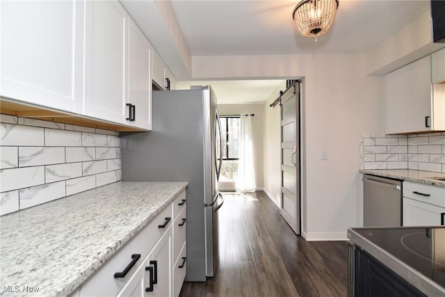kitchen with white cabinets, stainless steel appliances, and dark wood-type flooring