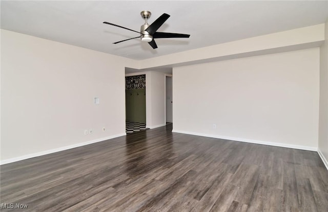 unfurnished room featuring baseboards, a ceiling fan, and dark wood-style floors