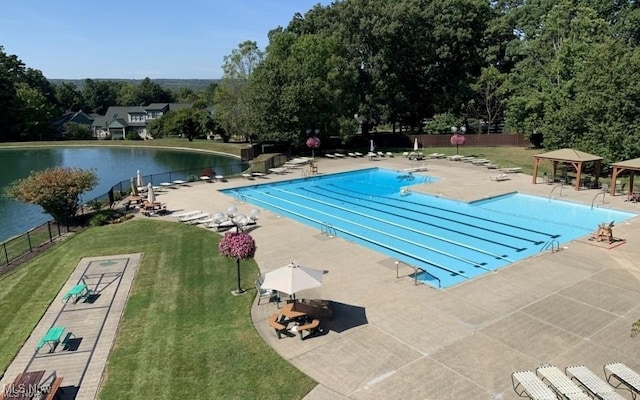 community pool with fence, a lawn, a gazebo, and a patio