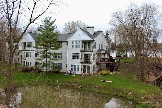 2004 Stoney Run Cir, Broadview Heights, OH 44147 - rear view of house with a chimney, stairs, a deck, and a lawn