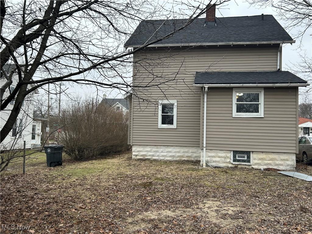 1098 Wyley Ave, Akron, OH 44306 - view of home's exterior with a chimney and a shingled roof