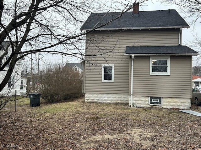 1098 Wyley Ave, Akron, OH 44306 - view of home's exterior with a chimney and a shingled roof