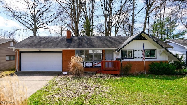view of front of home featuring a front yard, a garage, a chimney, concrete driveway, and brick siding