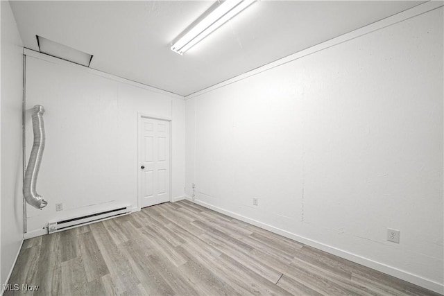 unfurnished room featuring a baseboard radiator and wood finished floors