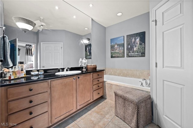 bathroom with a ceiling fan, tile patterned floors, a bath, vanity, and recessed lighting