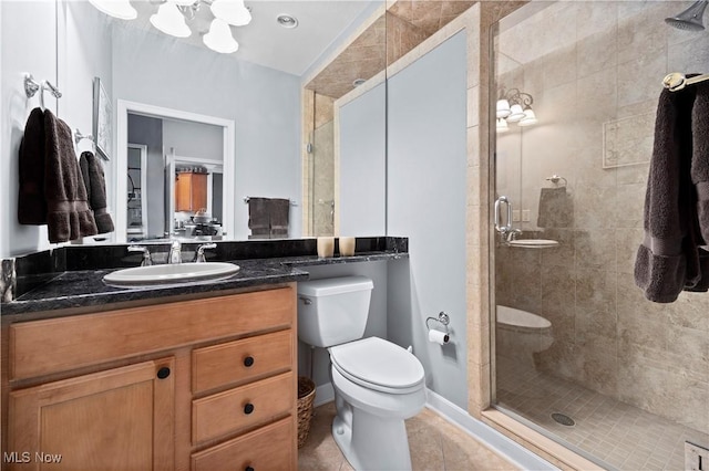 bathroom featuring toilet, vanity, tile patterned floors, and a stall shower
