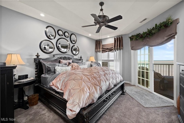 carpeted bedroom with recessed lighting, visible vents, a ceiling fan, access to exterior, and a water view