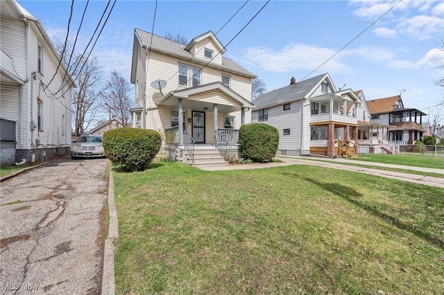 14117 Sylvia Ave, Cleveland, OH 44110 - traditional style home featuring a porch and a front yard