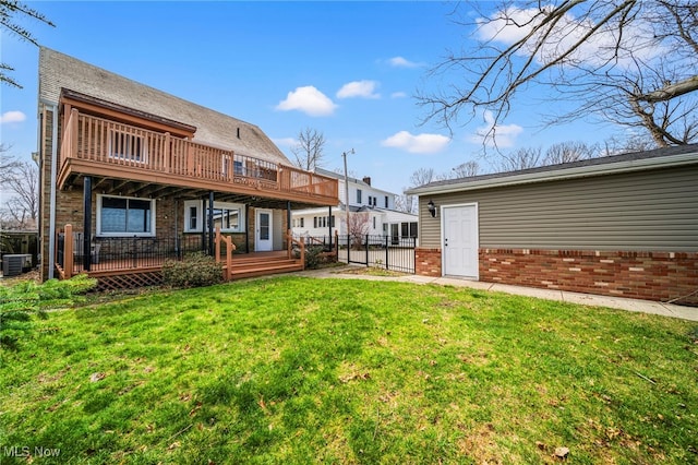 rear view of house featuring a deck, central AC unit, and brick siding