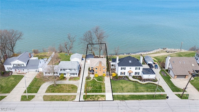 aerial view of residential area with a large body of water