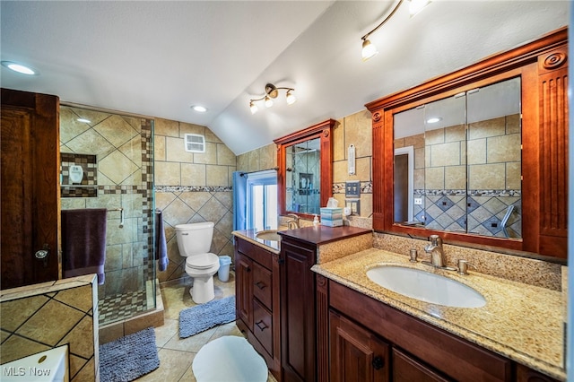 full bath with tile walls, toilet, tile patterned floors, a stall shower, and lofted ceiling