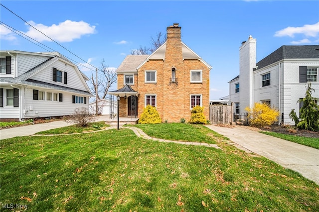 view of front of home with driveway and brick siding