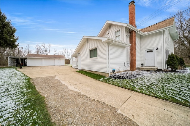 6232 S Ridge Rd W, Geneva, OH 44041 - view of property exterior with a chimney, a detached garage, and an outdoor structure