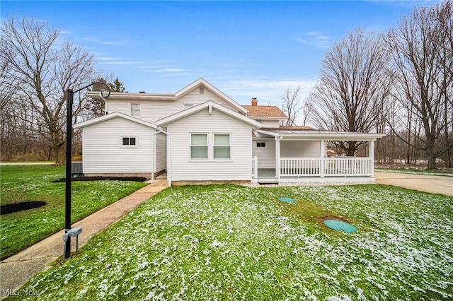 6232 S Ridge Rd W, Geneva, OH 44041 - view of home's exterior featuring a porch, a yard, and a chimney