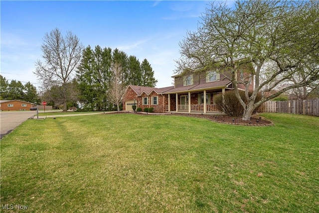 101 Keyser St, Marietta, OH 45750 - view of front facade featuring an attached garage, a front lawn, brick siding, fence, and covered porch