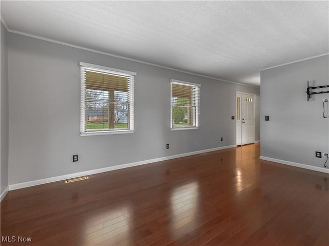 101 Keyser St, Marietta, OH 45750 - spare room featuring crown molding, wood finished floors, baseboards, and a textured ceiling
