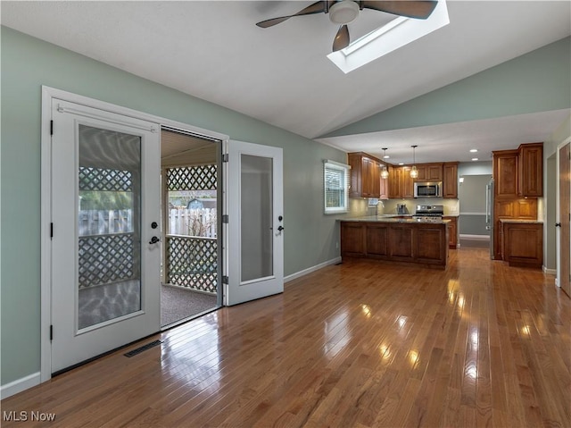 101 Keyser St, Marietta, OH 45750 - kitchen featuring a peninsula, dark wood-style floors, a ceiling fan, brown cabinets, and appliances with stainless steel finishes