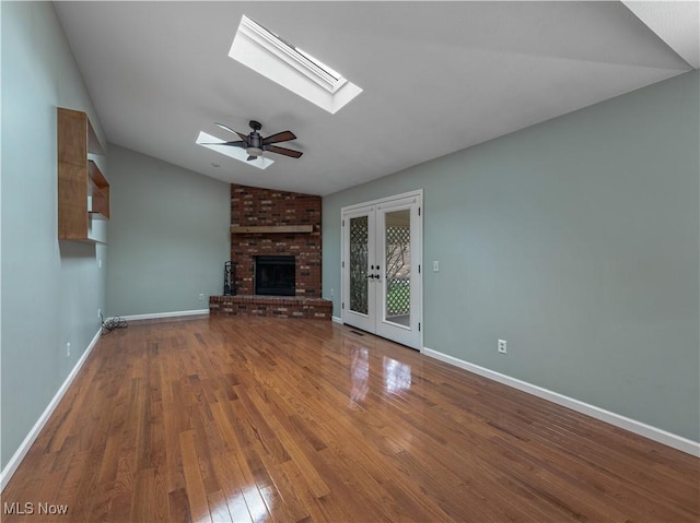 101 Keyser St, Marietta, OH 45750 - unfurnished living room featuring a brick fireplace, baseboards, and wood finished floors