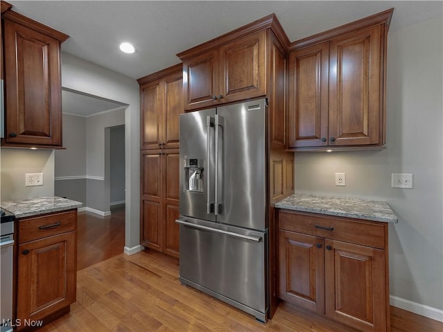 101 Keyser St, Marietta, OH 45750 - kitchen featuring light wood-style floors, light stone countertops, high quality fridge, recessed lighting, and baseboards