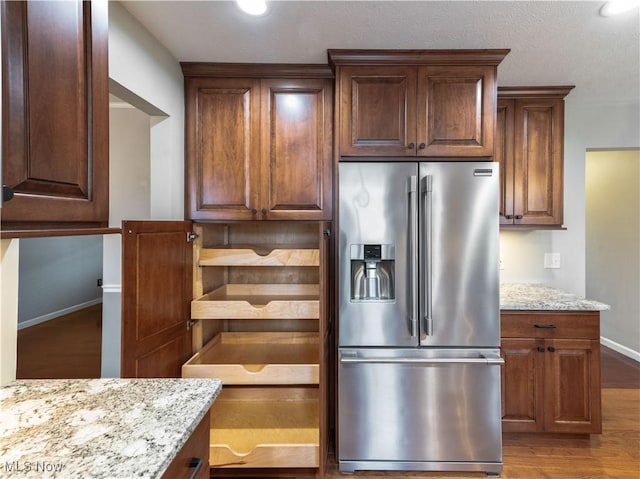101 Keyser St, Marietta, OH 45750 - kitchen with wood finished floors, baseboards, light stone counters, and high end fridge