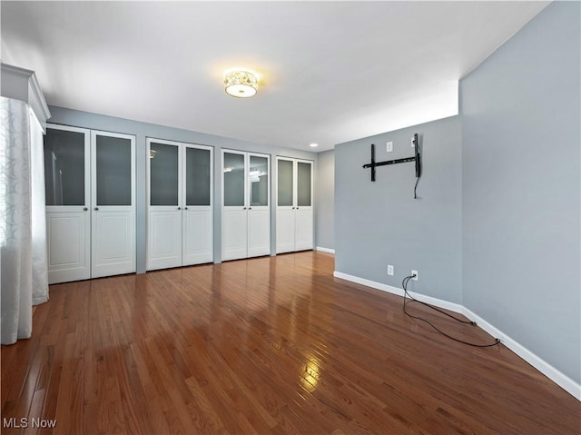 101 Keyser St, Marietta, OH 45750 - unfurnished bedroom with baseboards, two closets, and wood finished floors