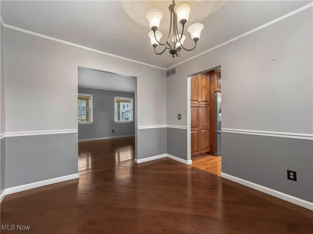 101 Keyser St, Marietta, OH 45750 - spare room featuring a chandelier, visible vents, crown molding, and light wood-style flooring