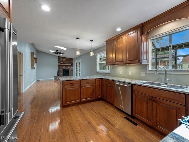 101 Keyser St, Marietta, OH 45750 - kitchen with open floor plan, light wood-style flooring, a brick fireplace, appliances with stainless steel finishes, and a sink