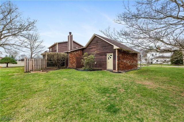 101 Keyser St, Marietta, OH 45750 - back of house with fence, a chimney, and a lawn
