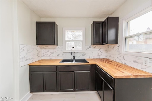 575 Fernwood Dr, Akron, OH 44320 - kitchen featuring wood counters, a sink, and backsplash