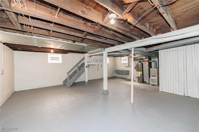 575 Fernwood Dr, Akron, OH 44320 - basement with stairway, water heater, a sink, and heating unit