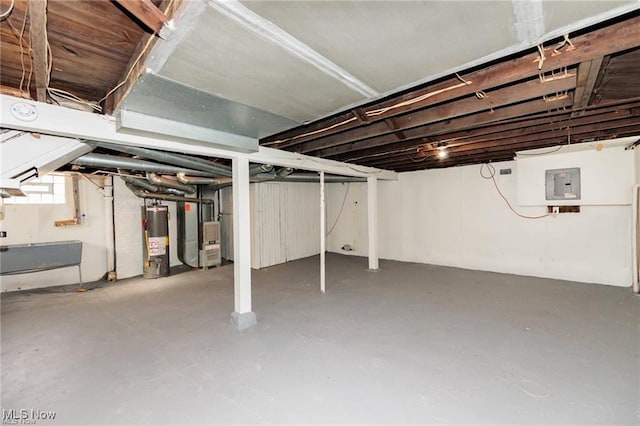 575 Fernwood Dr, Akron, OH 44320 - basement featuring electric panel, heating unit, and gas water heater