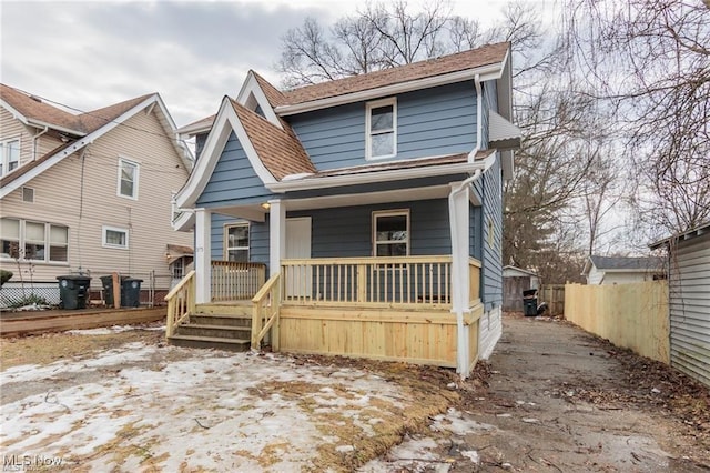 575 Fernwood Dr, Akron, OH 44320 - view of front facade with a porch, fence, and a shingled roof