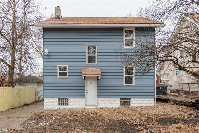 575 Fernwood Dr, Akron, OH 44320 - rear view of property with fence and a chimney