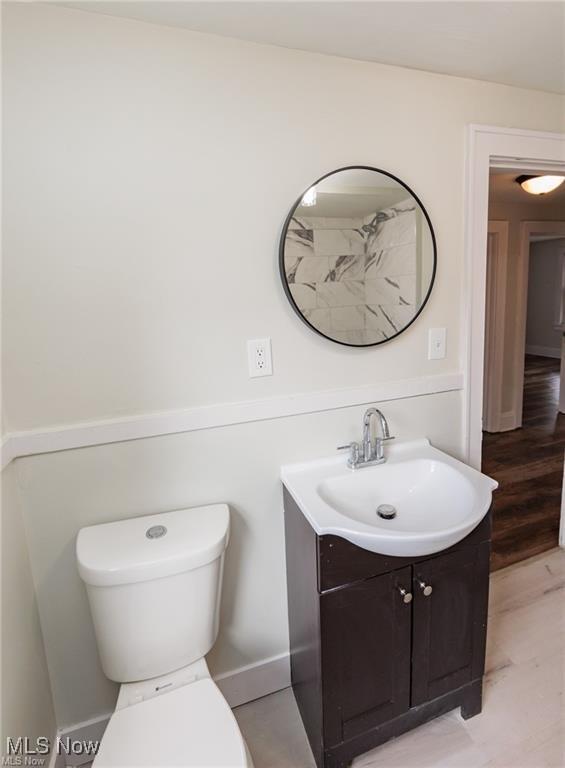 575 Fernwood Dr, Akron, OH 44320 - bathroom featuring toilet, wood finished floors, and vanity