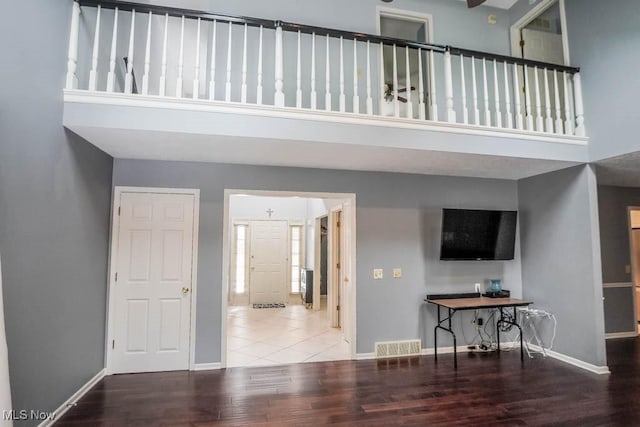 4989 Belden Park Dr NW, North Canton, OH 44720 - living area featuring visible vents, a high ceiling, baseboards, and wood finished floors