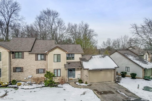 4989 Belden Park Dr NW, North Canton, OH 44720 - traditional home with brick siding, a garage, and aphalt driveway