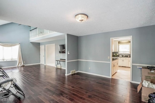 4989 Belden Park Dr NW, North Canton, OH 44720 - living area with visible vents, baseboards, and wood finished floors