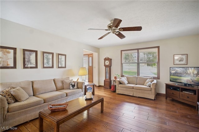 living room featuring hardwood / wood-style floors and a ceiling fan