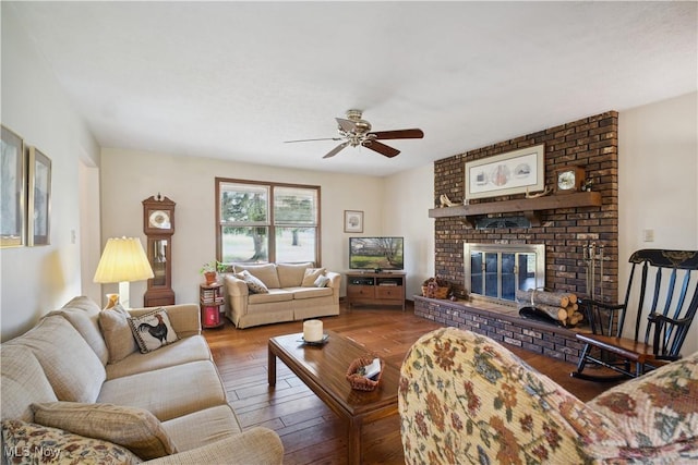 living room with ceiling fan, wood finished floors, and a fireplace