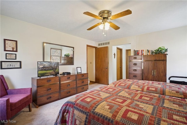 bedroom featuring visible vents and light carpet