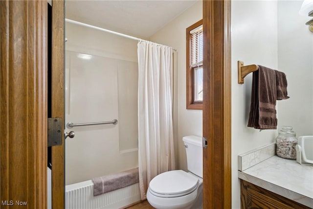 full bathroom with a shower with shower curtain and toilet