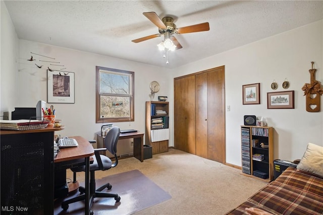 office featuring carpet flooring, baseboards, a textured ceiling, and ceiling fan