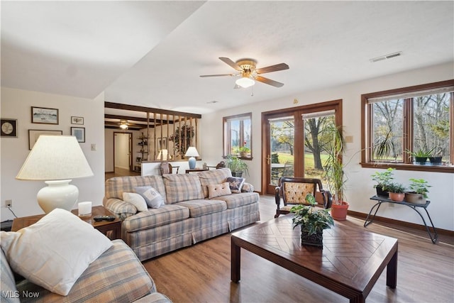 living area featuring a healthy amount of sunlight, visible vents, and ceiling fan