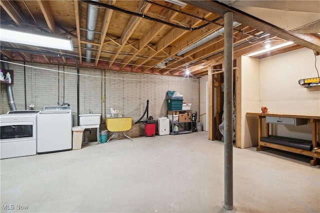 unfinished basement featuring a sink and separate washer and dryer