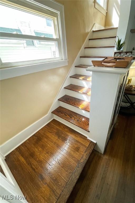 stairs featuring wood-type flooring and baseboards
