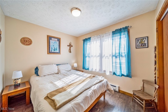2457 Sheffield Rd, Jefferson, OH 44047 - bedroom with a baseboard radiator, wood finished floors, a textured ceiling, and baseboards