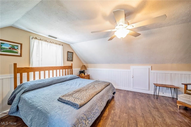 2457 Sheffield Rd, Jefferson, OH 44047 - bedroom with vaulted ceiling, wood finished floors, a textured ceiling, wainscoting, and ceiling fan