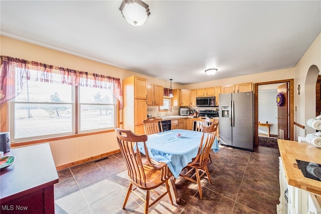 2457 Sheffield Rd, Jefferson, OH 44047 - dining space with baseboards, dark tile patterned floors, and arched walkways